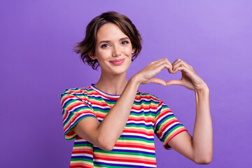 Fototapeta premium Portrait of lovely nice girl arms fingers demonstrate heart symbol isolated on purple color background