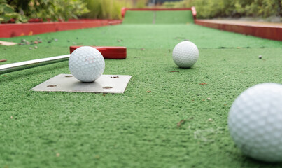 Mini golf close-up, colorful golf putters, balls