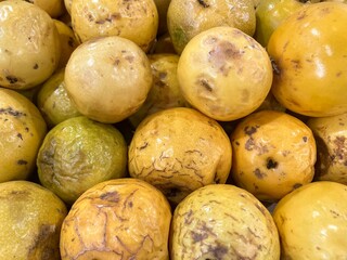 Pile of fresh passion fruits on Brazilian market stall for sale.