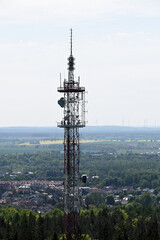 A 95 m high transmitter mast. Aerial view of mobile phone cell tower over forested rural area. Radio and Television Broadcasting Center. A station transmitting radio and television waves. 