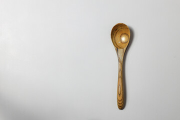 Empty wooden spoon isolated on Background.