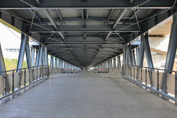 Pedestrian pathway or corridor or hallway between train station and building.	