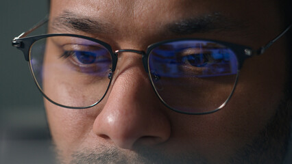 Close up male eyes in eyeglasses laptop monitor light programming codding cyberspace man businessman wear computer glasses reducing eye strain blurred vision looking at pc screen computer reflection