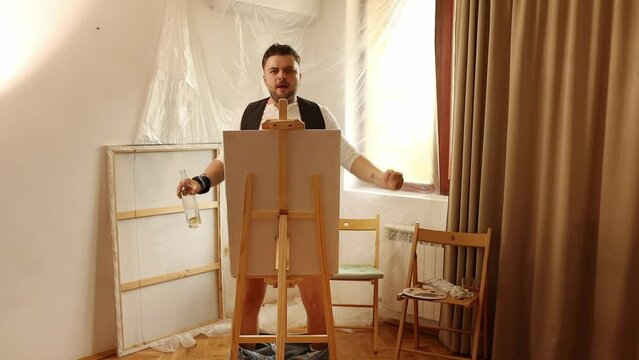 Drunk man artist paints a picture with his penis