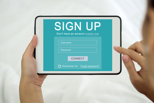 A focused woman engrossed in creating her identity online, registering for an account on tablet computer. Digital Life Exploration. - Powered by Adobe