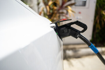 Electric battery car charge at EV station at night