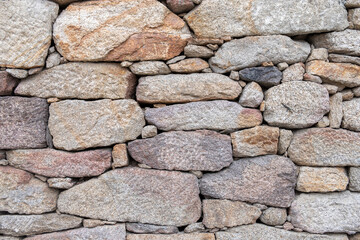 wall of irregular granite stones, background textured