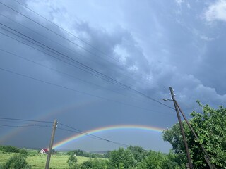 beautiful view of a rainbow in the sky in the countryside