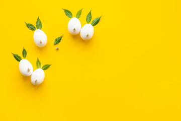Easter layout with bunnies made of eggs and leaves. Top view