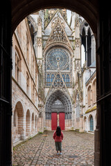 Person standing in front of a side entrance to the Cathédrale Notre-Dame de Rouen (Rouen, France)
