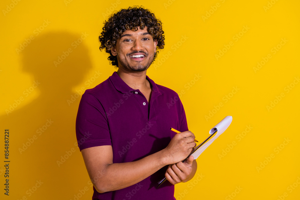 Wall mural photo portrait of attractive young man write documents dressed stylish violet clothes isolated on ye