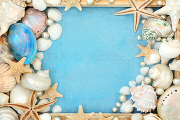 Seashell and pearl decorations abstract background border with gold grunge frame on mottled blue...