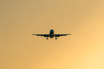 airplane landing at sunset