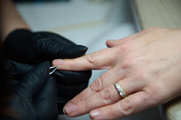 Manicure session in a beauty salon with gloved hands