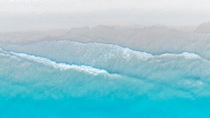 Tropical Beach with the soft wave water of the sea on the sandy beach background as texture with...