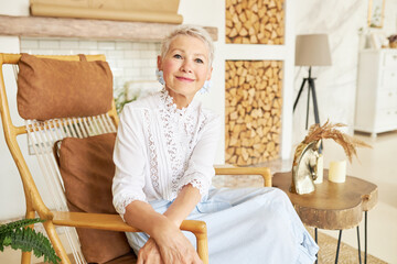 Indoor portrait of confident independent successful wealthy elderly stylish caucasian female in...