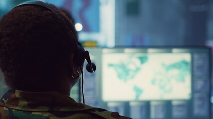 Woman military personnel tracking enemy vessels on the coast line territory, working on national...
