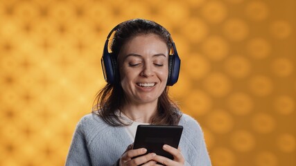 Voice actor smiling while reading ebook, portraying proud and sassy character, studio background....