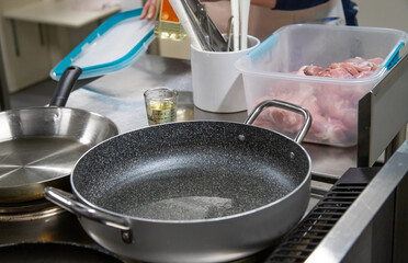 Pans with oil stand on the stove, cooking, real picture in the kitchen