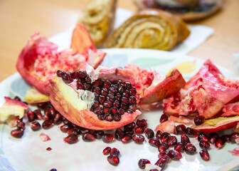 Opened pomegranate close-up, pieces of fruit, pomegranate seeds, still life