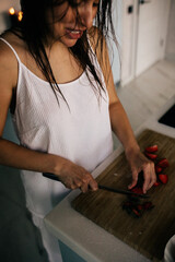 Beautiful woman in the kitchen preparing food. 
