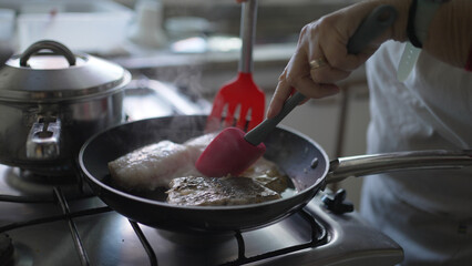 Close-Up of Fish Being Fried in a Pan - Senior's Culinary Skills in Action