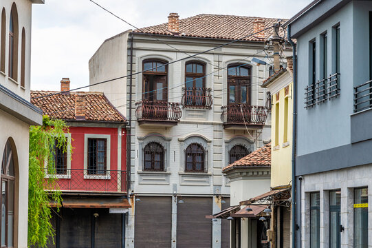 A view down a side street towards ornate buildings in Korca, Albania in summertime