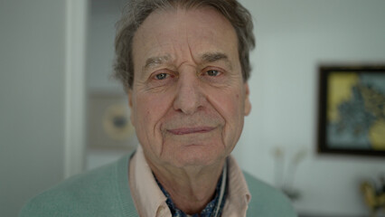 Close-Up Portrait of an Elderly Man with Warm Smile in a Cozy Home Environment