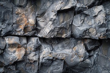 The image is of a rocky wall with a lot of cracks and crevices