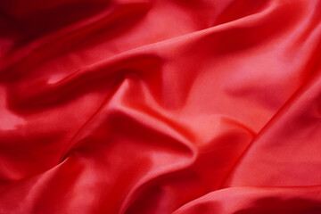 Texture red satin or silk is beautiful and luxurious (blurred).