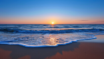 Obraz premium The ocean is calm and the sun is setting, creating a beautiful