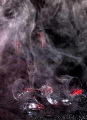 Glasses of wine in smoke. Beautiful smoke around glasses of red wine.