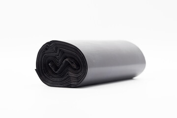 Black plastic garbage bags on white background, Roll of garbage bags on white background