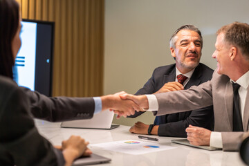 Image two business partner meeting successful handshake together with success join congratulation good deal contract in modern office.Partnership approval and teamwork concept