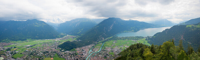 view from harder Kulm to lake Thunersee, grey thunderclouds above. landscape switzerland