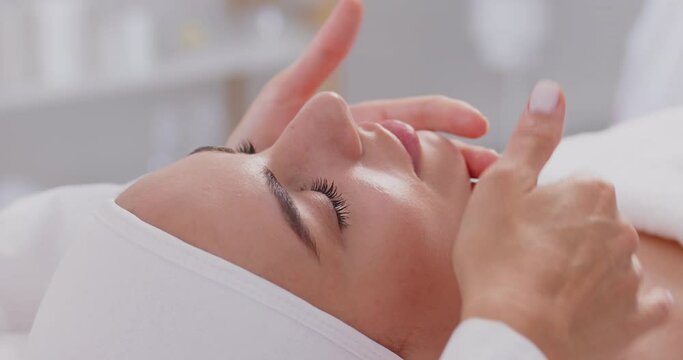 Cosmetologist performing female face gentle care, skin condition anti age massage to help relieve stress and reduce tension to refresh, relaxing therapeutic practice in spa salon or beauty clinic