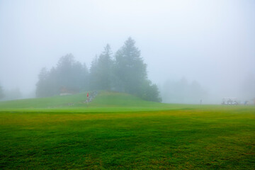 Golf Course Hole 18 with Fog in Crans Montana, Valais, Switzerland.