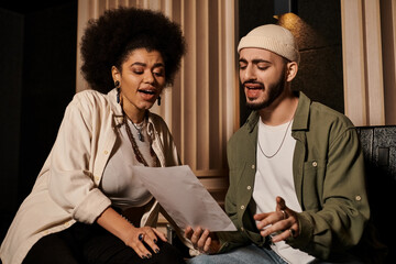 A man and a woman sit in a recording studio, immersed in a music band rehearsal.
