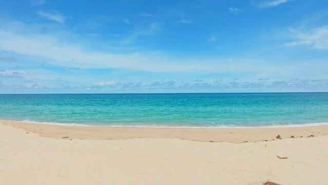 Beautiful Sea Beach in summer season,Waves crashing on sandy shore, White clouds and blue sky footage from drone,High angle view nature background