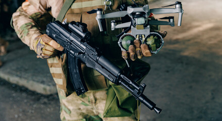 Concept modern war with technology UAV robots. Army soldier launches drone with bomb to drop to...