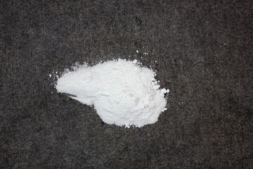 Drug, a powder. Powdered narcotic substance on a black background