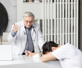 Fototapeta premium Senior doctor is measuring with tonometer blood pressure of his young patient in modern medical office