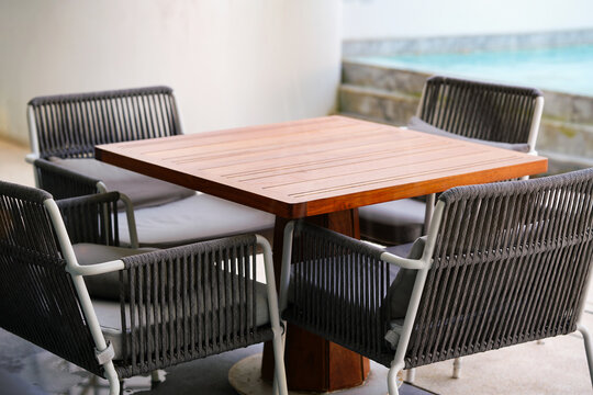 table and chairs beside blur pool, outside