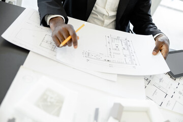 Successful man architect working on estate construction project in the office
