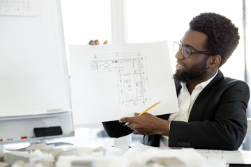 Successful man architect working on estate construction project in the office