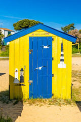 Yellow and blue beach hut of La boirie beach in Saint-Denis d'Oleron, France