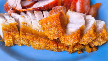Crispy pork rice on a blue plate on the dining table