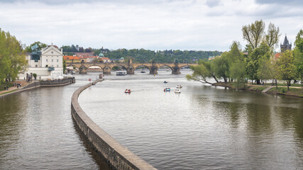 Obraz premium The Vltava River with water bikes near the Charles Bridge in Prague, Czech Republic, Europe.