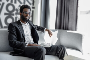 Picture of a successful and confident african american businessman with a laptop
