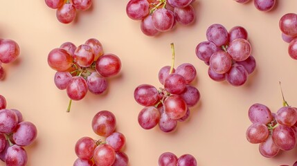 Red grapes on pastel background, top view. Fresh fruit pattern concept